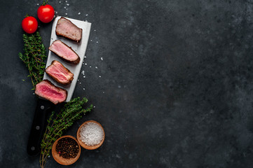  Four steaks on knife on a stone background. Four types of meat frying Rare, Medium, Medium Good, Well done with copy space for your text 