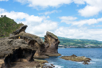 Fototapeta na wymiar Amazing landscape in the Azores, Portugal. Large rocks against the blue sky on the uninhabited volcanic island of Vila Franca. Travel to the Azores.