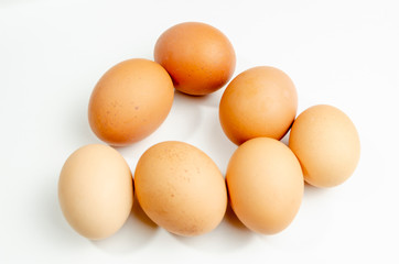 group of fresh brown chicken eggs on a white background