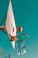 basketball ball falling towards the hoop in the afternoon © Paulo