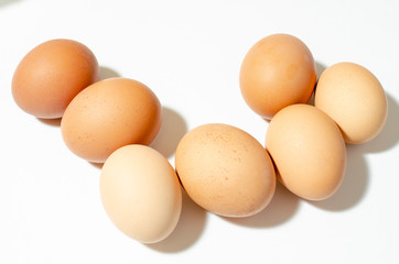 group of fresh brown chicken eggs on a white background