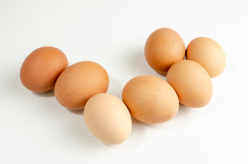 group of fresh brown chicken eggs on a white background