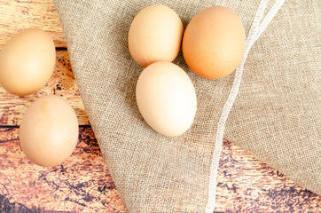 several brown chicken eggs on a dark background close-up