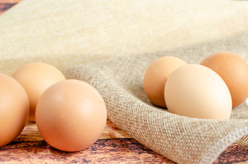 several brown chicken eggs on a dark background close-up