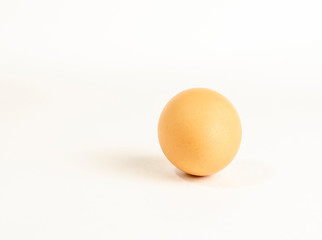 one fresh brown chicken egg on a white background