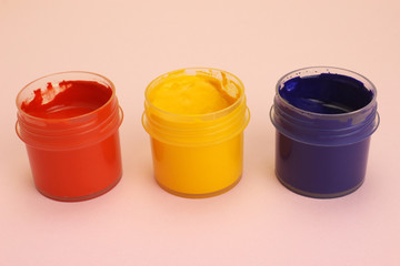 Gouache cans on a pink background