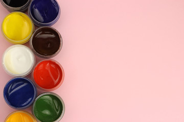 Gouache cans on a pink background with space for text