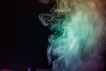 Colorful smoke flowing in a dark background. Abstract backdrop with fume and colorful light effect. Mystic dream. Colorful dust explode. Paint Holi. Halftone smoke effect. Vibrant abstract background.