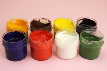 Gouache cans on a pink background