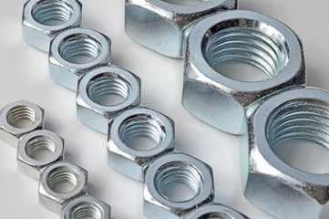 Big and small screw-nut. Concept. White background.