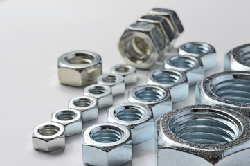 Big and small screw-nut. Concept. White background.