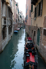 Fototapeta na wymiar Narrow Venice Canal With Gondola