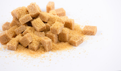 Brown sugar on a white background, healthy sugar used for cooking or desserts.