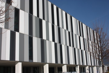 Public hospital healthcare facility in Italy in a building in northern Tuscany made of gray white and black vertical rectangular textures