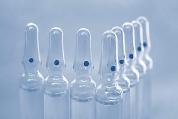 Glass ampoules close up. Medical ampoules. Medical ampoules on a blue background.