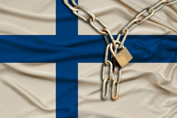 iron chain and castle on Finland's silk national flag with beautiful folds, the concept of a ban on...