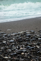 Pebble beach in perspective, close-up. Seashore background.