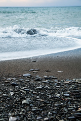 Pebble beach in perspective, close-up. Seashore background.