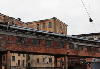 Fototapeta na wymiar old industrial brick building, abandoned factory, industrial area, criminal territory.
