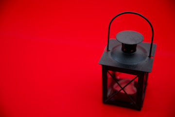 kerosene lamp on a red background