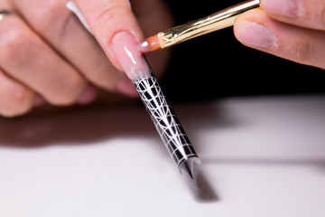 extension of nails on the little finger shape using disposable tips