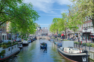 Beautiful Amsterdam Canals with boats docked alongside houses Netherlands