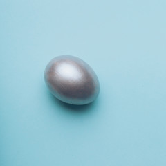 Silver easter egg on a blue background.