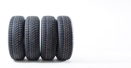 four black tires isolated on white background