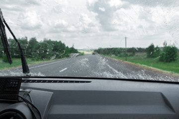Fototapeta na wymiar Cleaning the car's windshield with a windscreen wiper