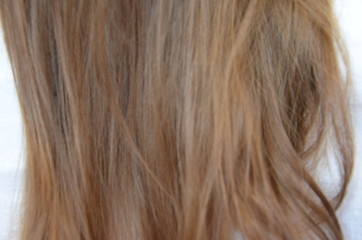 piece of brown hair on white isolated background healthy and shiny