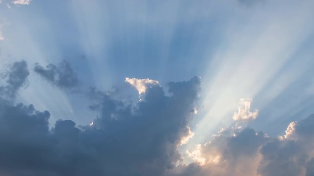 Dramatic sunburst or sun rays or god light beam through the cloud – Time Lapse
