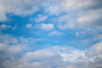 Blue sky with white fancy piles of clouds.