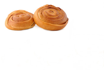 Two bread pastry swirls on a white background