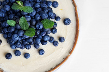 Sweet tasty cheesecake on table