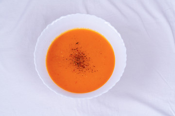 plate with traditional borscht (beetroot soup) on white table.