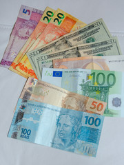 Close up on diverse currencies bank notes, American Dollar, Euro, Brazilian Real