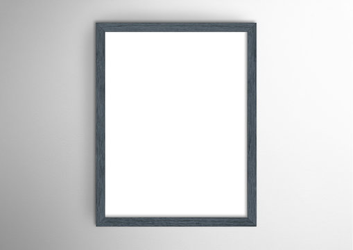 Empty frame. Blank dark grey portrait frame on white wall