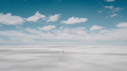 Car in the middle of Uyuni Salt Flats, Bolivia