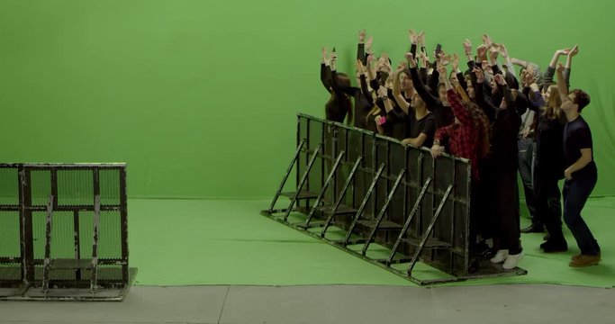 GREEN SCREEN CHROMA KEY Model released, Front view of huge crowd dancing and cheering at a concert or a show behind control barrier. Shot on RED Helium 8K Prores 4444