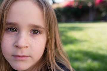 Close up of a young girl with adorable freckles in the summertime. 