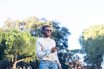 Afro young man using mobile phone.