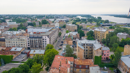 Fototapeta na wymiar Aerial view photo from flying drone panoramic view of Riga's bridges, the Daugava River, the TV Tower and the city skyline on a sunny summer day in Riga, Latvia. (series)