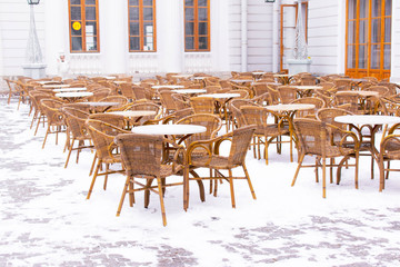 The restaurant with white tables and chairs is located in the courtyard.