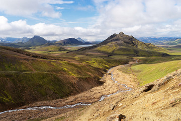 View mountain valley with green hills, river stream and lake. Laugavegur hiking trail, Iceland
