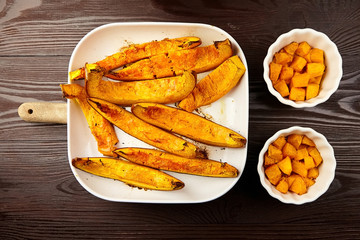 Slices of baked pumpkin in white ceramic bowl