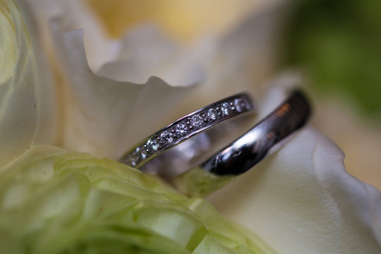 The wedding bouquet and silver rings. Shallow DOF