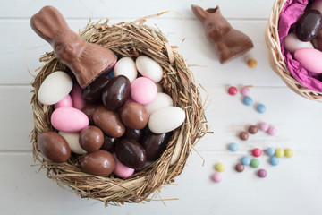 Top view of Easter sweets on white wooden table