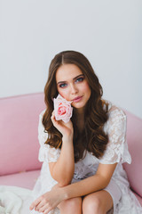 Close-up portrait of young beautiful model with rose