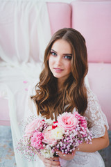 Close-up portrait of young beautiful bride with spring bridal bouquet