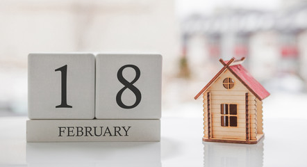 February calendar and toy home. Day 18 of month. Card message for print or remember